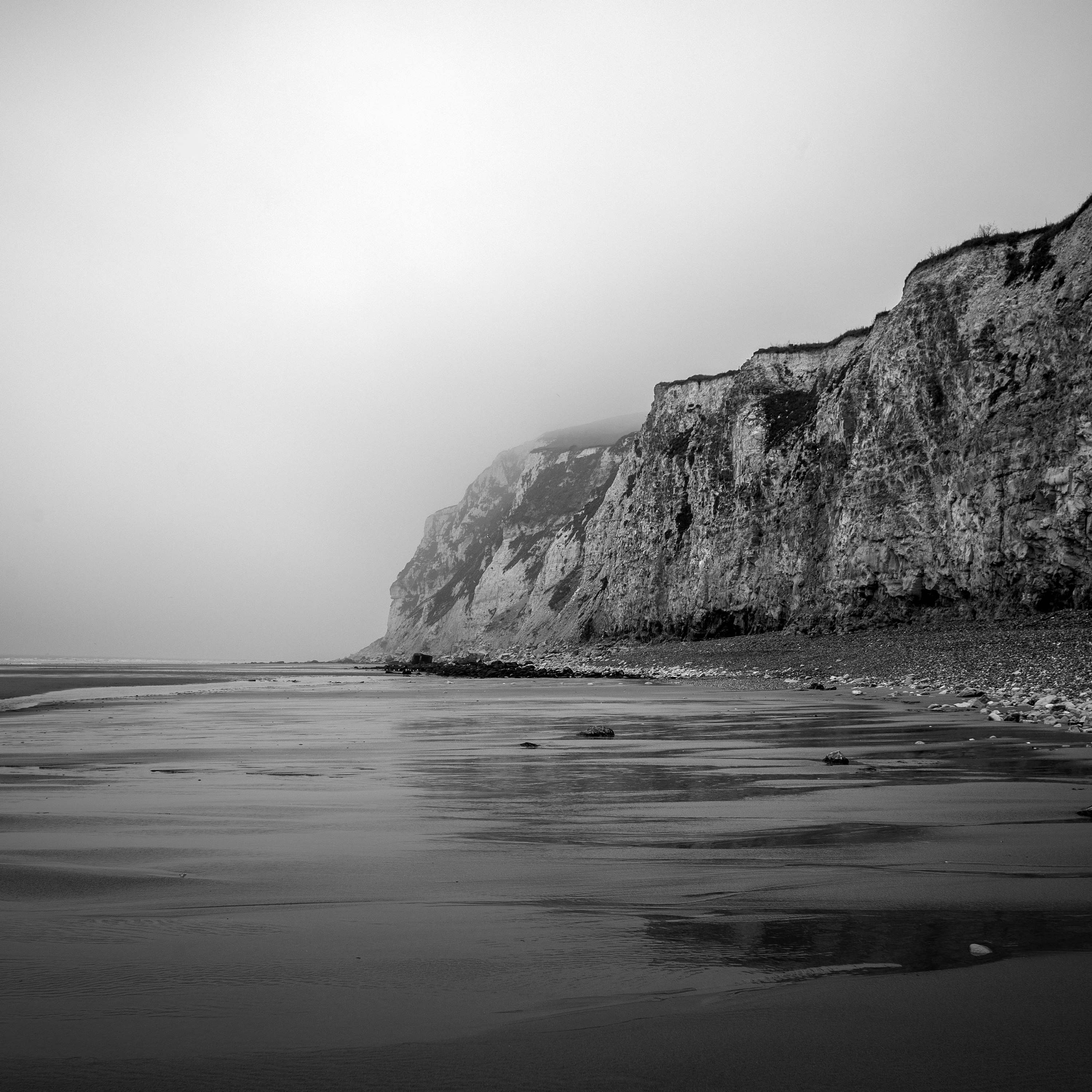 cliff beside body of water